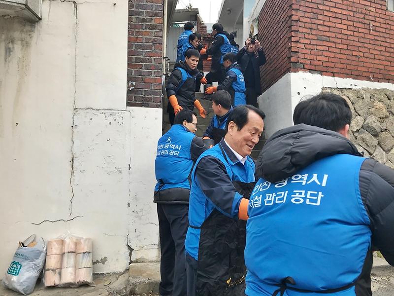 공단 임직원들과 함께 연탄을 나르고 있는 이응복 이사장.JPG 이미지